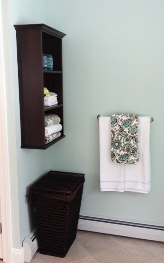 photo of custom open shelf unit, towel bar and hamper