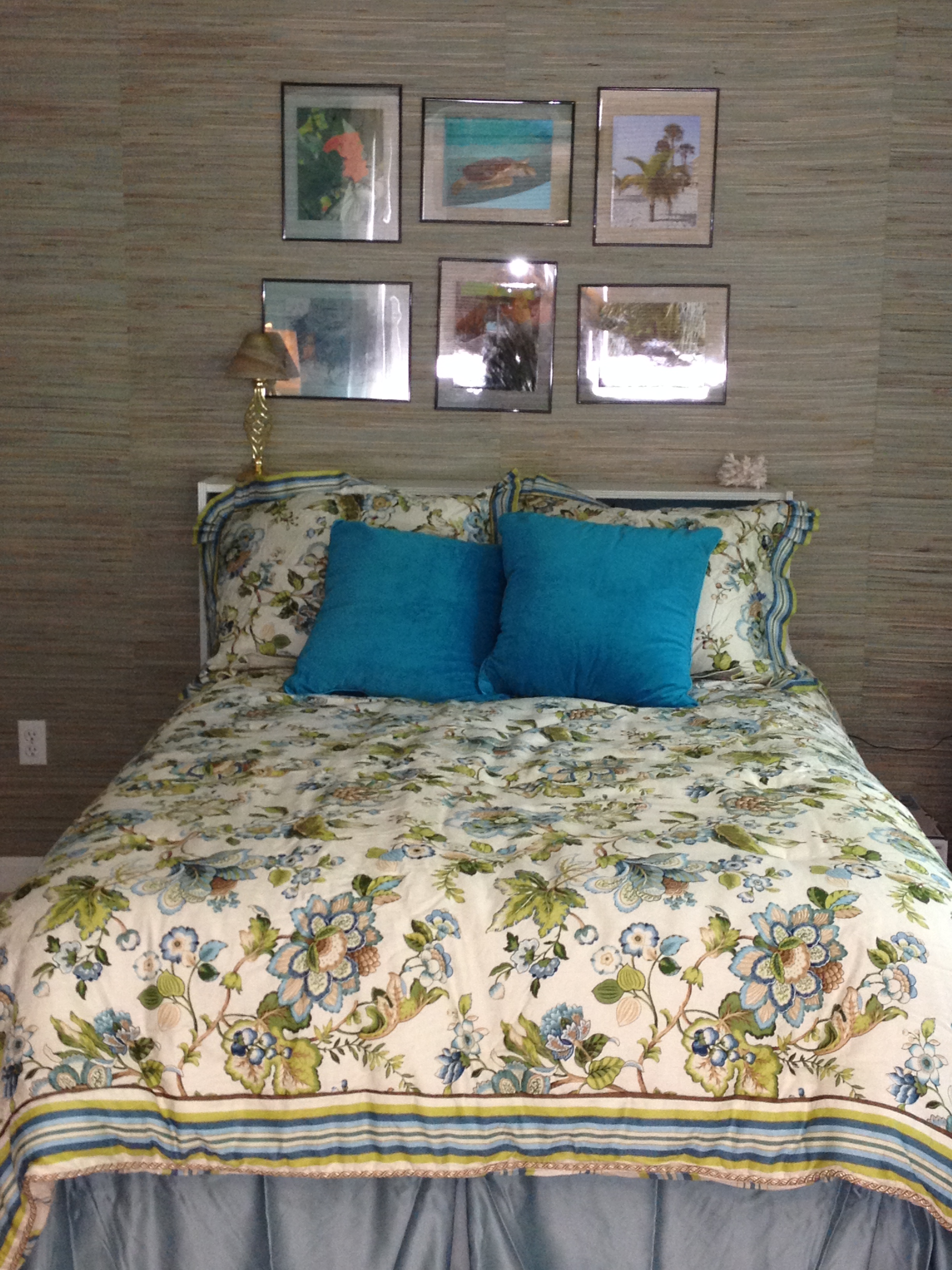 photo of bed against grasscloth wallpaper wall with frameless floating photos