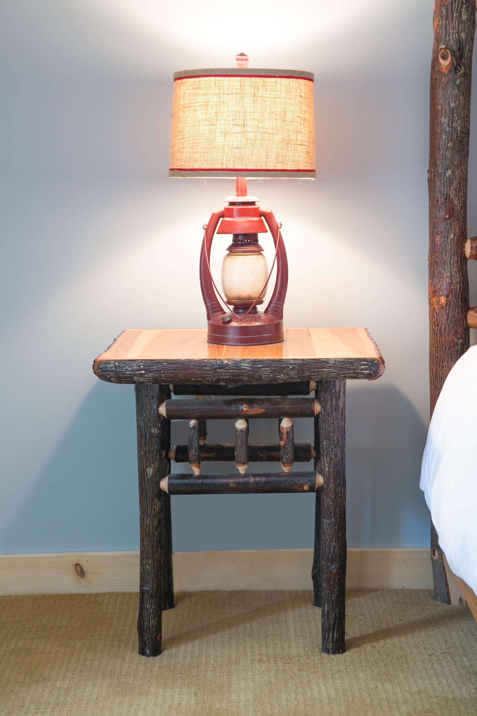 photo of hickory log nightstand and lantern lamp